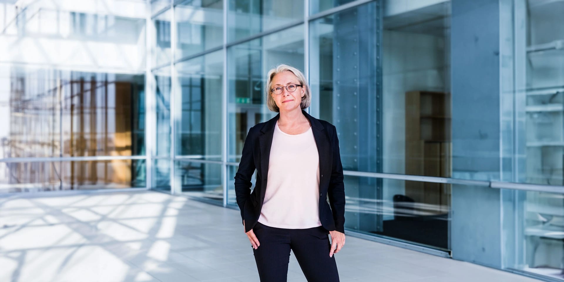 An employee stands in front of the glass building of Uniper's headquarters in Düsseldorf.